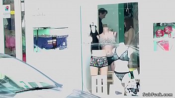 Asian posing naked at shop window