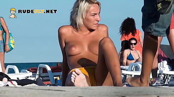 This girl nudist strips bare at a public beach